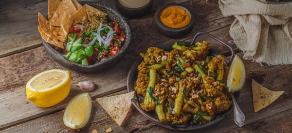 Deep Fried Cauliflower with eggplant salad and crusty bread, copy space.