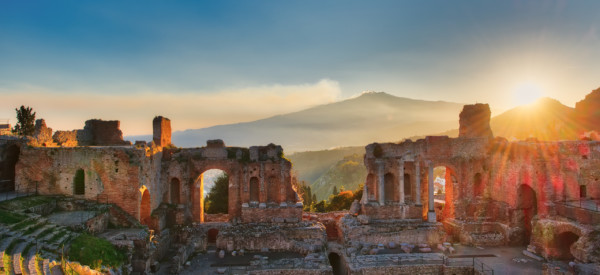 Particular of Ancient theatre of Taormina  Sicily Italy with Etna  erupting volcano at sunse
