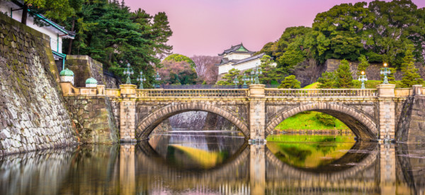 Tokyo, Japan at the Imperial Palace moat and bridge at dawn.