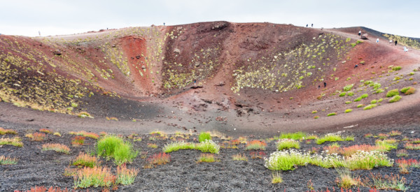 travel to Italy - tourists on edge of big crater on Mount Etna in Sicily in summer day