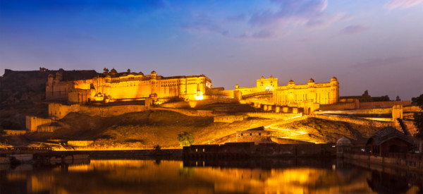 Amer Fort Amber Fort illuminated at night - one of principal attractions in Jaipur, Rajastan, India refelcting in Maota lake in twilight