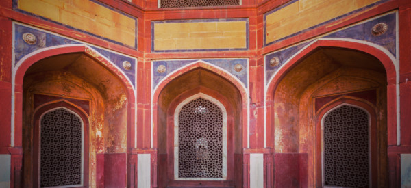 Vintage retro effect filtered hipster style travel image of arch with carved marble window. Mughal style. Humayun's tomb, Delhi