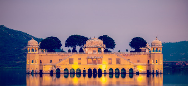 Vintage retro hipster style travel image of Rajasthan landmark - Jal Mahal (Water Palace) on Man Sagar Lake in the evening in twilight.  Jaipur, Rajasthan, India